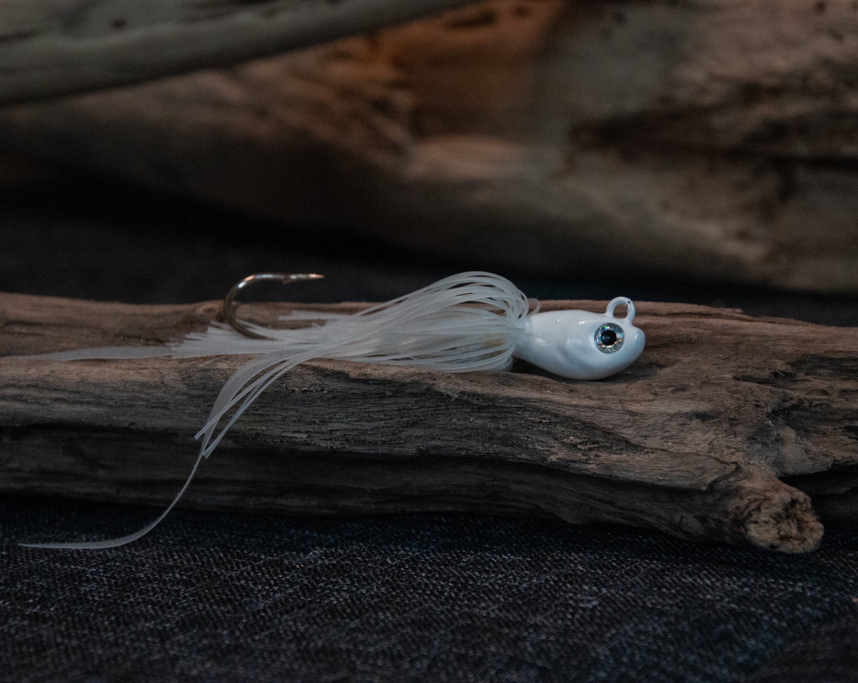 White 1oz swing hook bucktail jig for saltwater striped bass, fluke, black sea bass fishing.