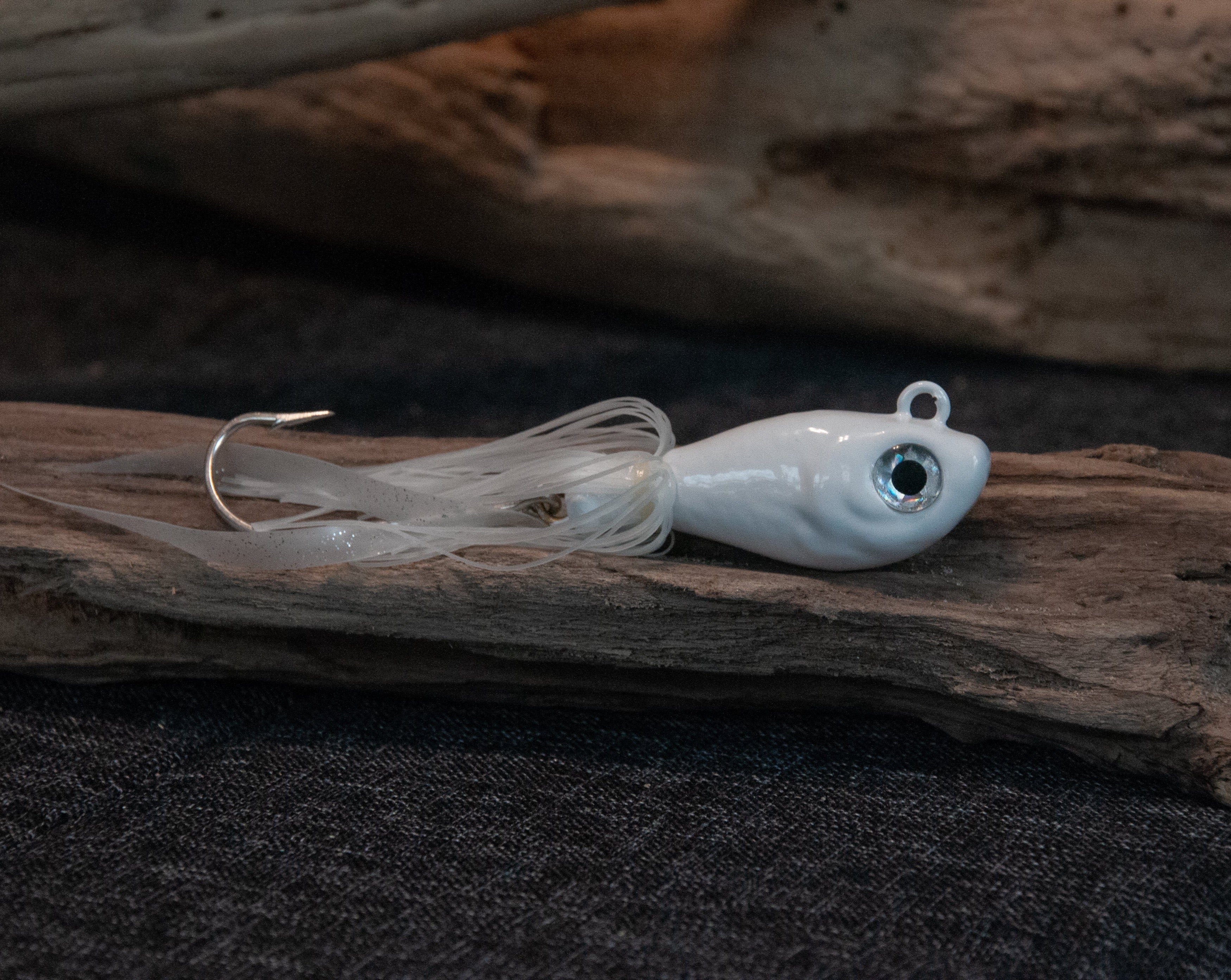 White 6oz swing hook bucktail jig for saltwater striped bass, fluke, black sea bass fishing.