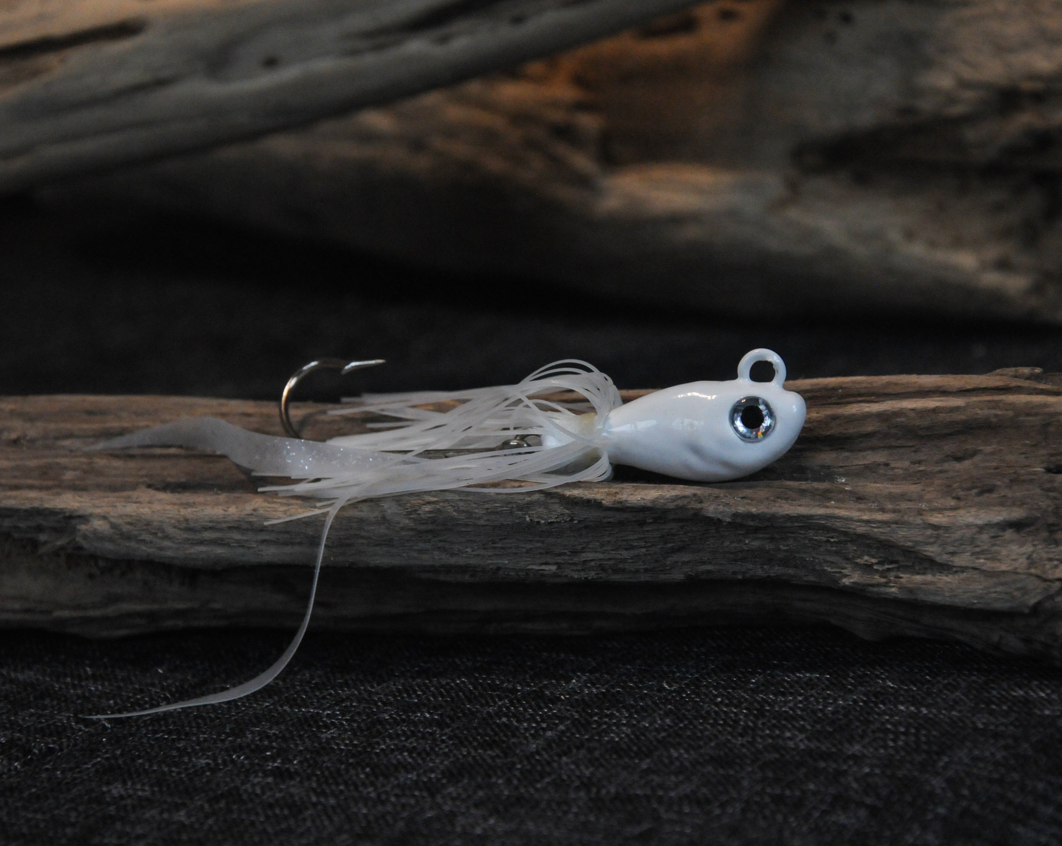 White 2oz swing hook bucktail jig for saltwater striped bass, fluke, black sea bass fishing.
