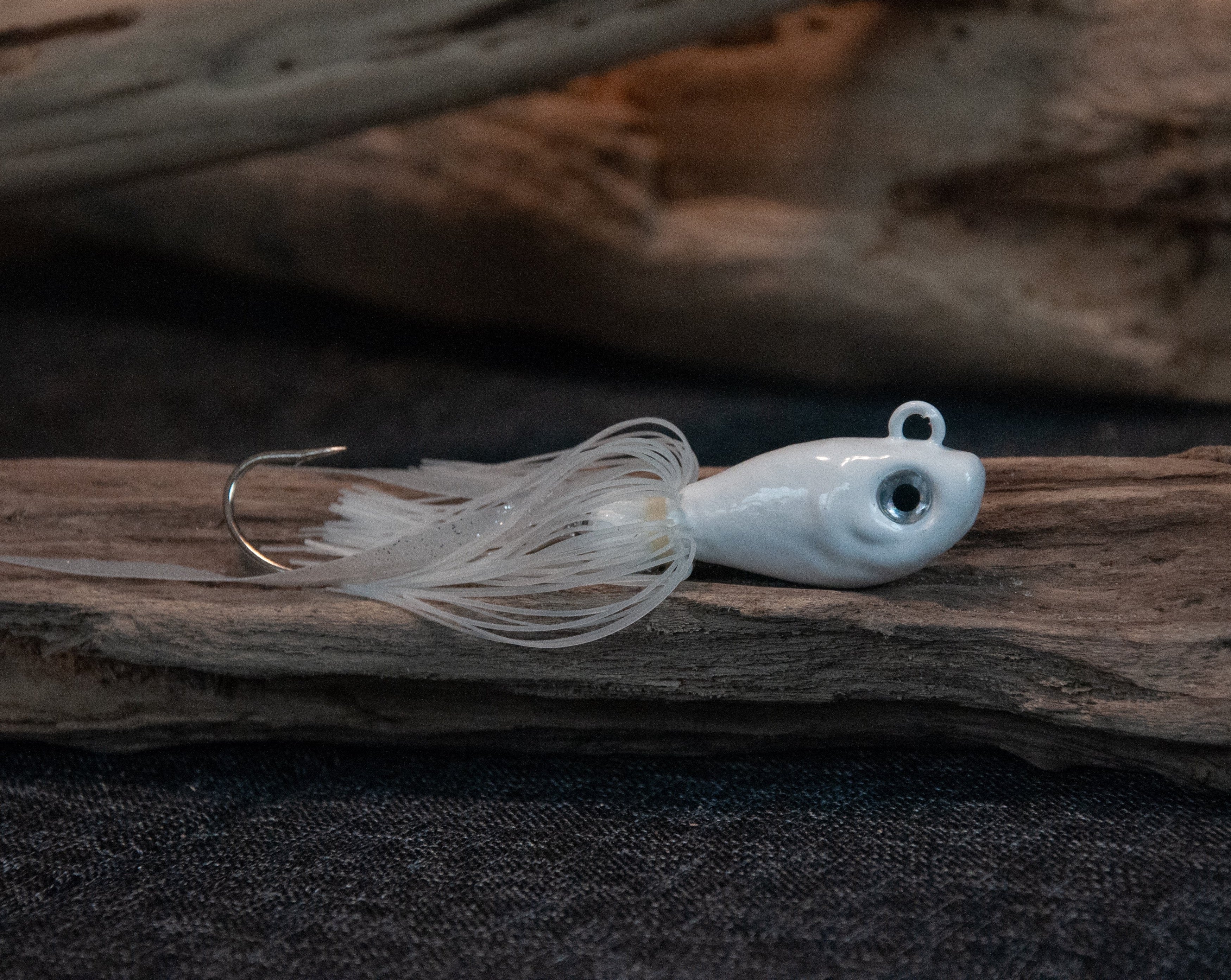 White 4oz swing hook bucktail jig for saltwater striped bass, fluke, black sea bass fishing.