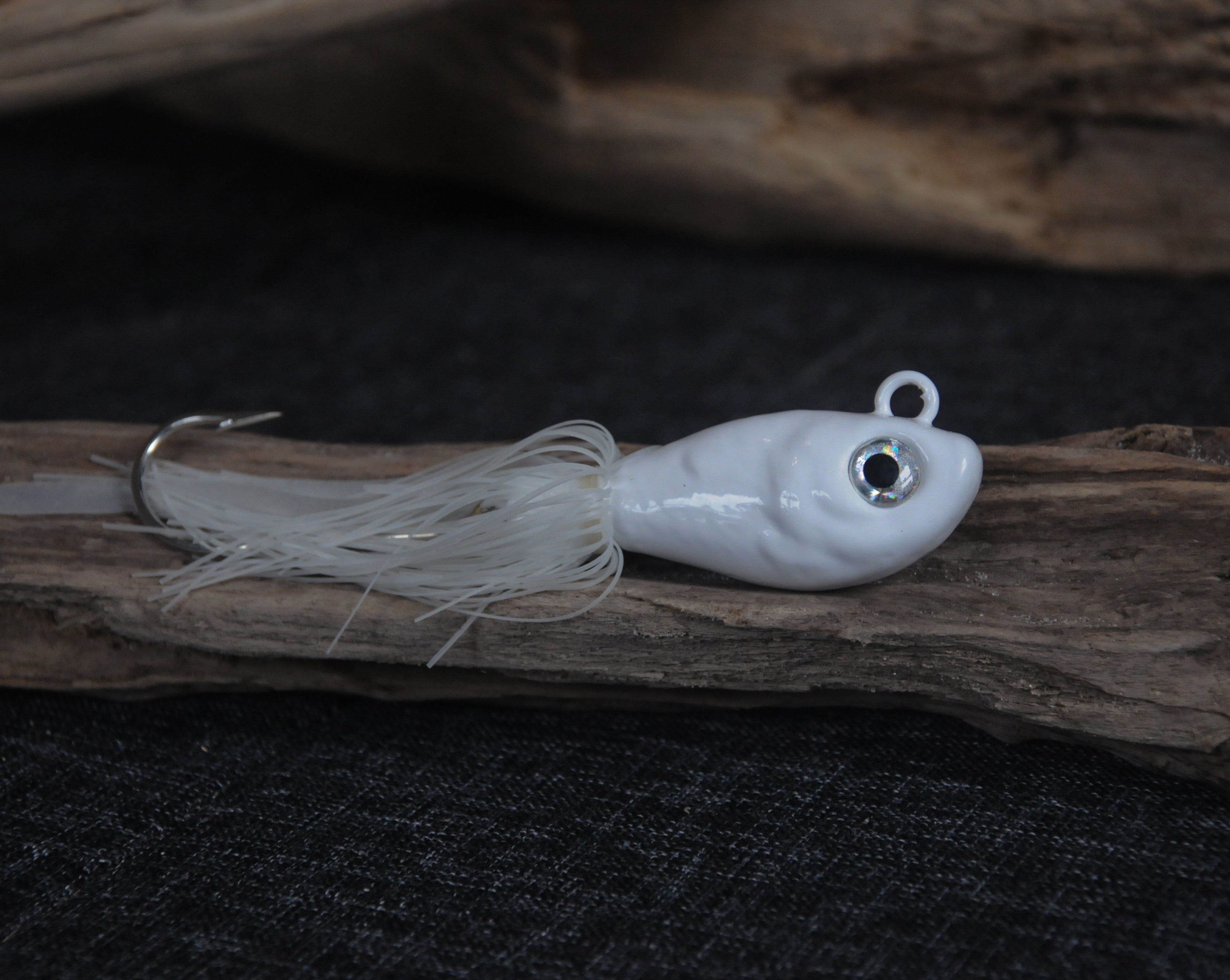 White 8oz swing hook bucktail jig for saltwater striped bass, fluke, black sea bass fishing.